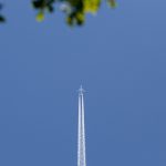 Commercial plane with cloud trails