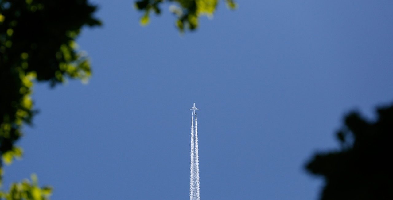 Commercial plane with cloud trails